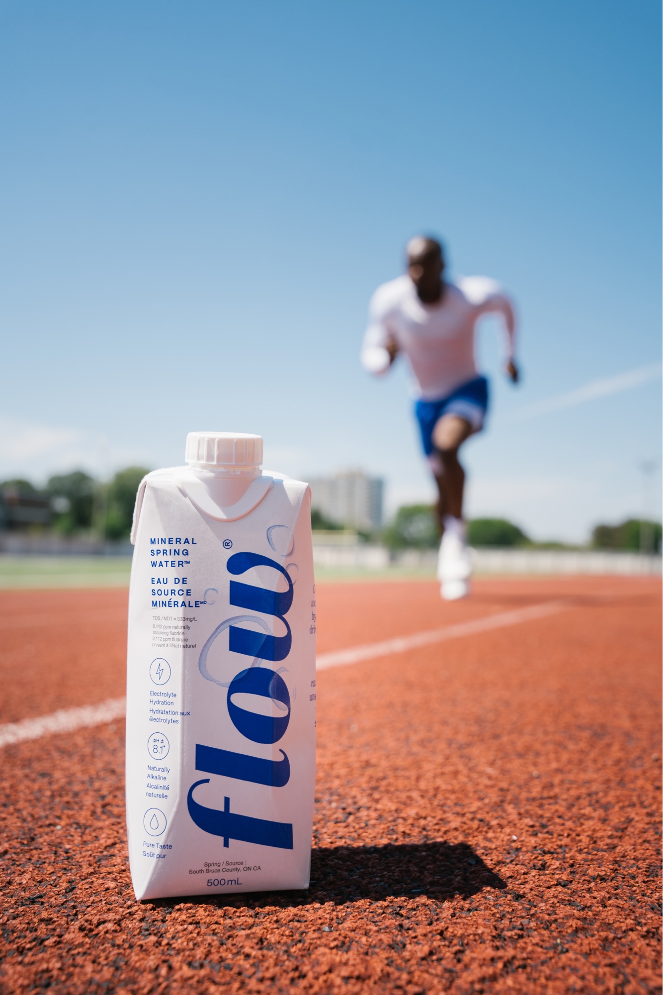 Flow Water carton in foreground with Duan running behind