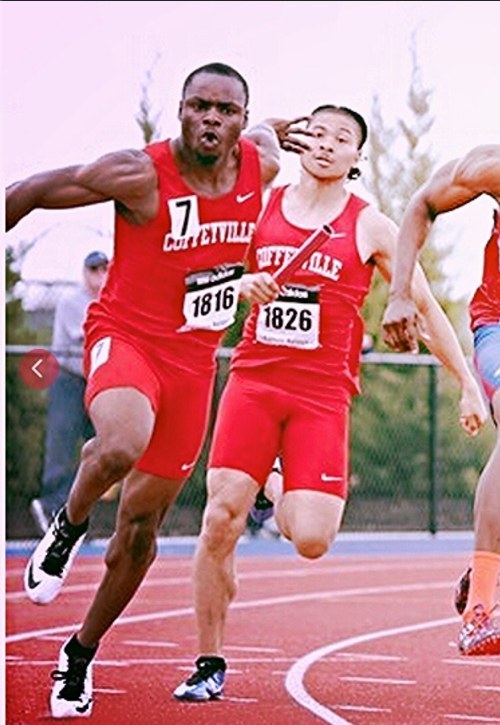Duan Asemota in the Coffeyville Red Ravens singlet racing against Kansas at a JUCO meet