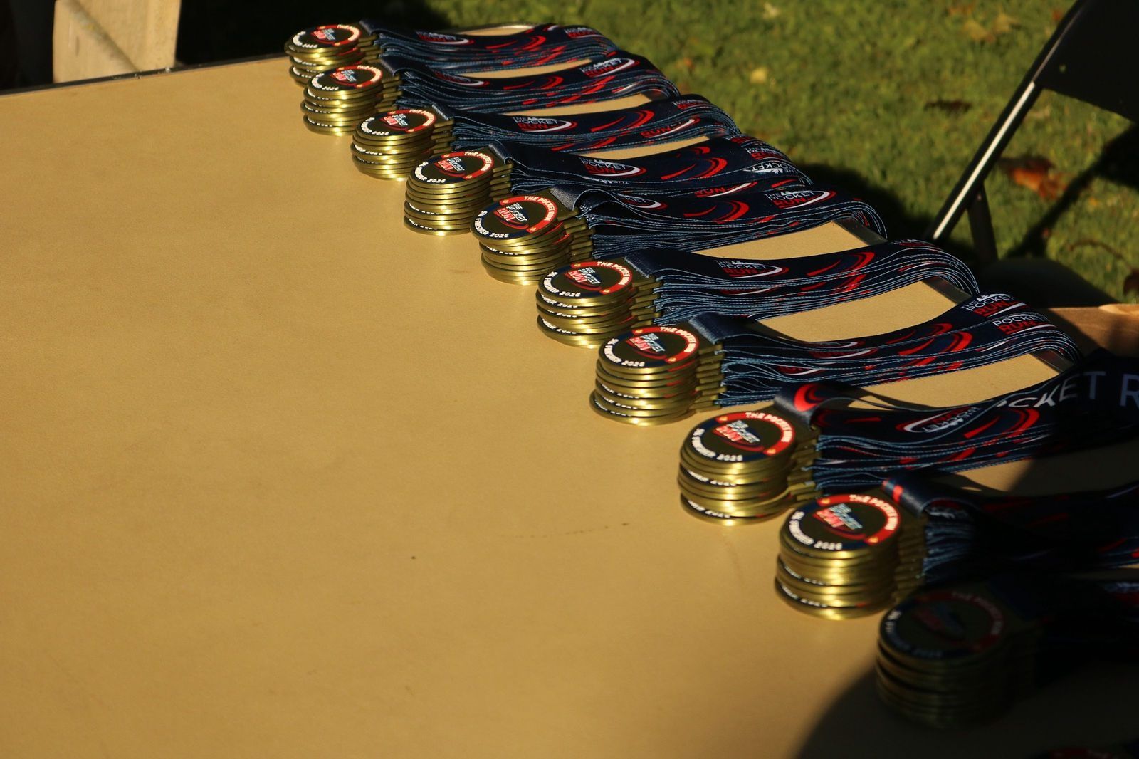 Pocket Run finisher medals laid out on a table