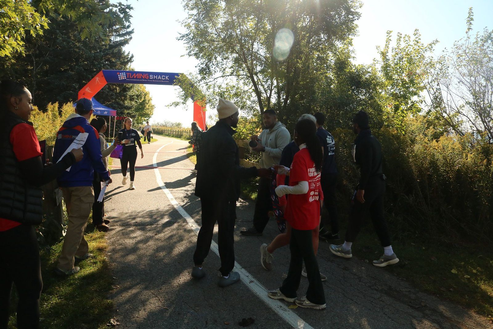 Runners and volunteers near the start and finish arch at The Pocket Run