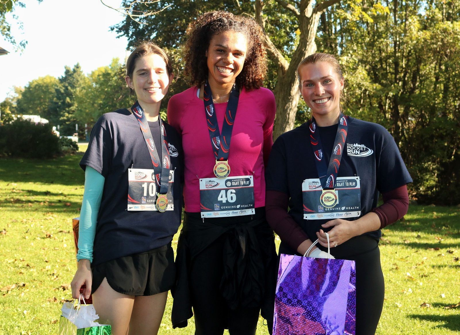 Three finishers wearing Pocket Run medals