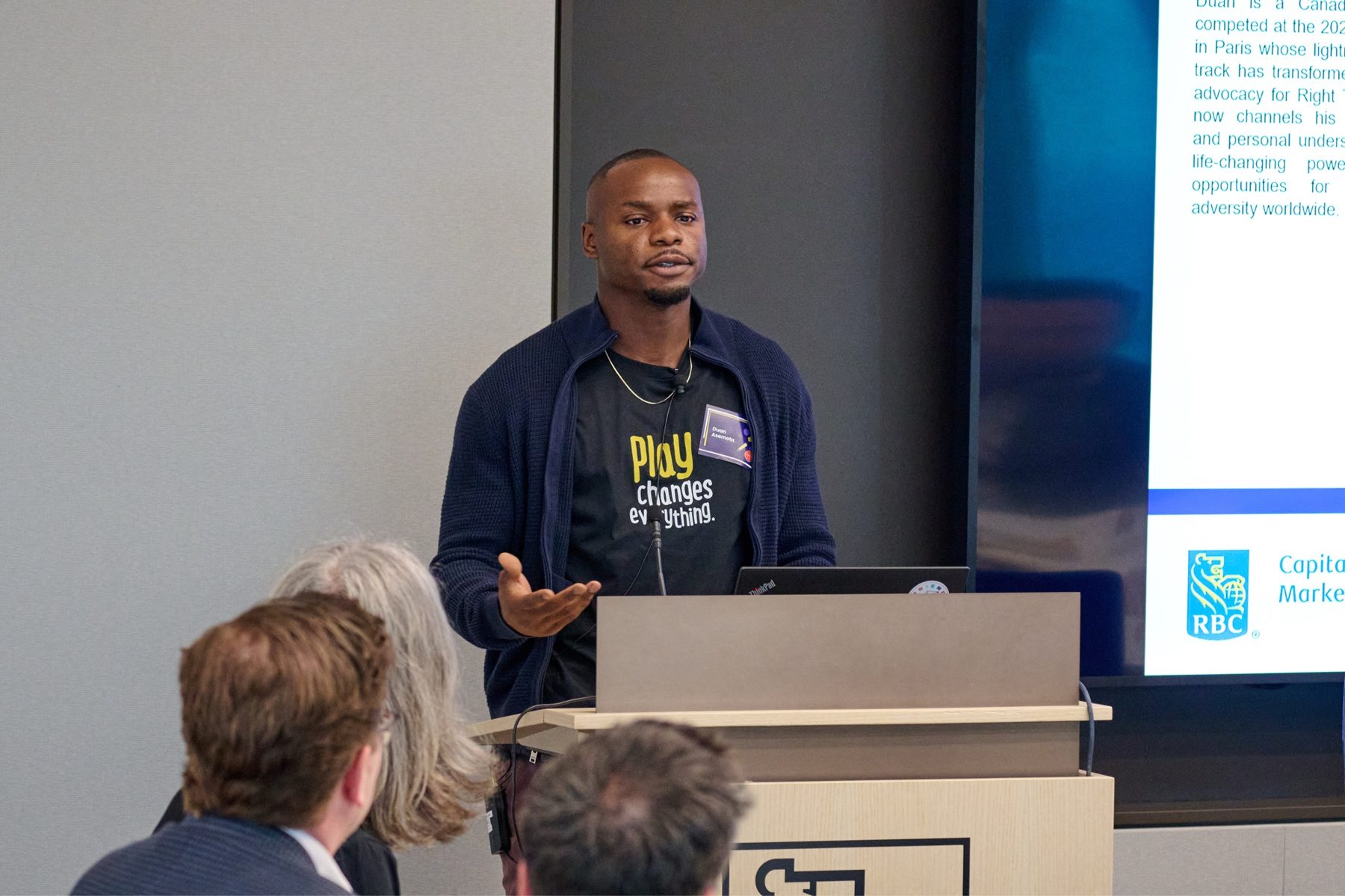 Duan Asemota speaking at the podium